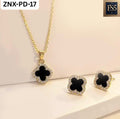 Gold-tone necklace and stud earrings set with black clover-shaped pendants surrounded by clear stones