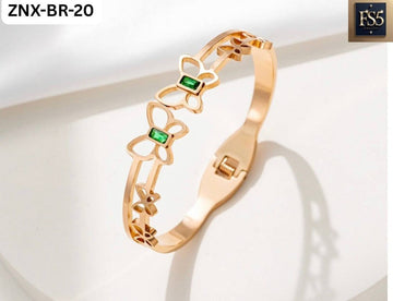 Gold bracelet with butterfly cutouts and green rectangular stones accent
