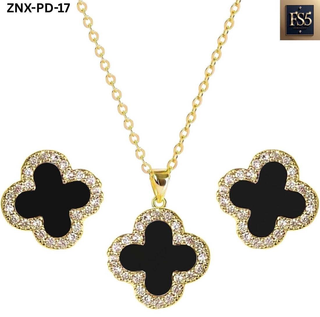 Gold-tone necklace and stud earrings set with black clover-shaped pendants surrounded by clear stones