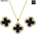 Close-up front view of matching black clover necklace and stud earrings with gold settings