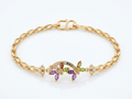 Close-up image of multi-stone gold plated bracelet on white background