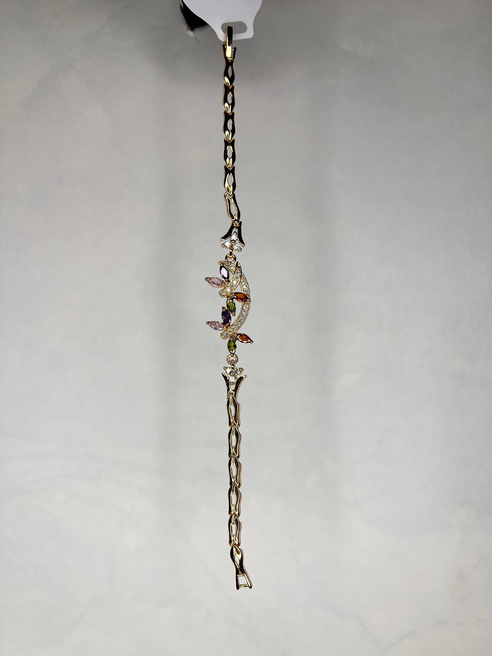 Gold plated multi-stone bracelet displayed against a light gray background